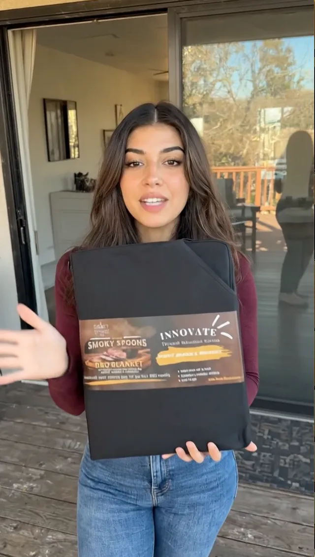 Woman on her patio holding the Smoky Spoons BBQ Blanket insulated meat resting bag